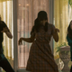 Umbrella Academy cast members dance in a scene from the Netflix series.